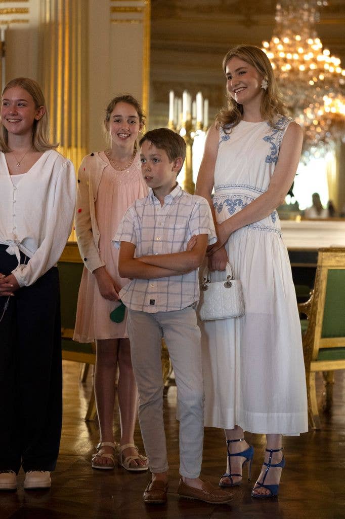Princess Elisabeth in white dress beside kids at palace