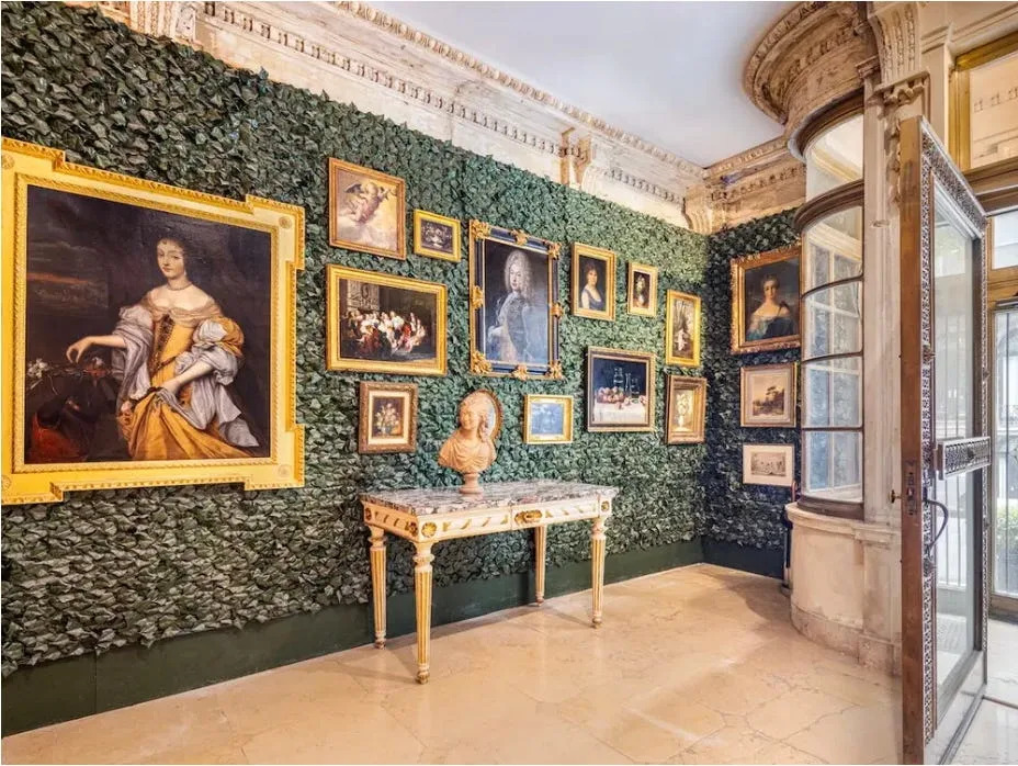 The House of Cassini entryway features an unusual vestibule of marble, brass and curved glass.