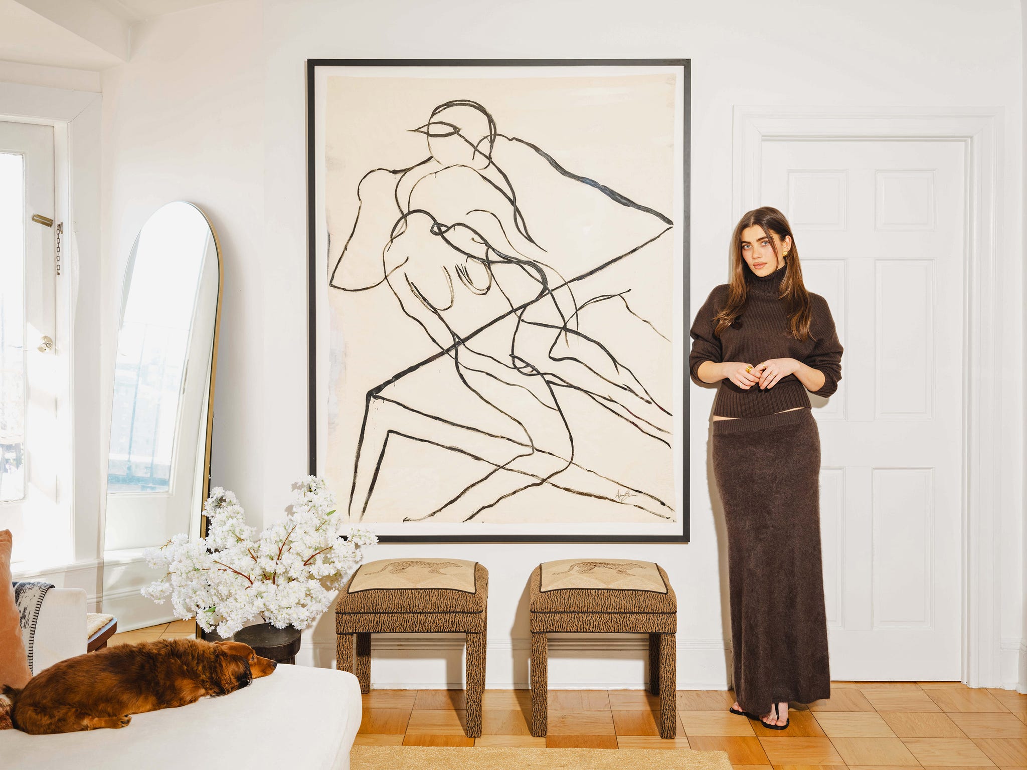 Interior scene with abstract art and a seated dog