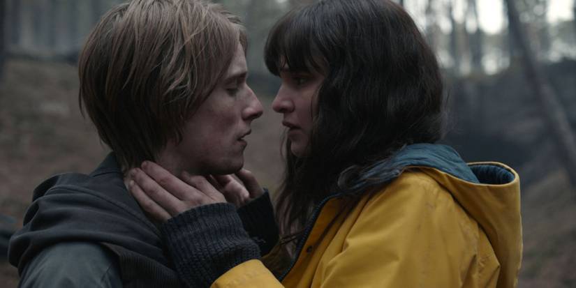 Louis Hofmann and Lisa Vicari standing very close face to face outdoors in an episode of Dark.