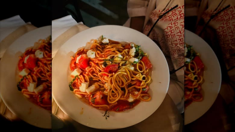 bowl of spaghetti with tomatoes, cheese, and basil at Malatesta Trattoria in New York City
