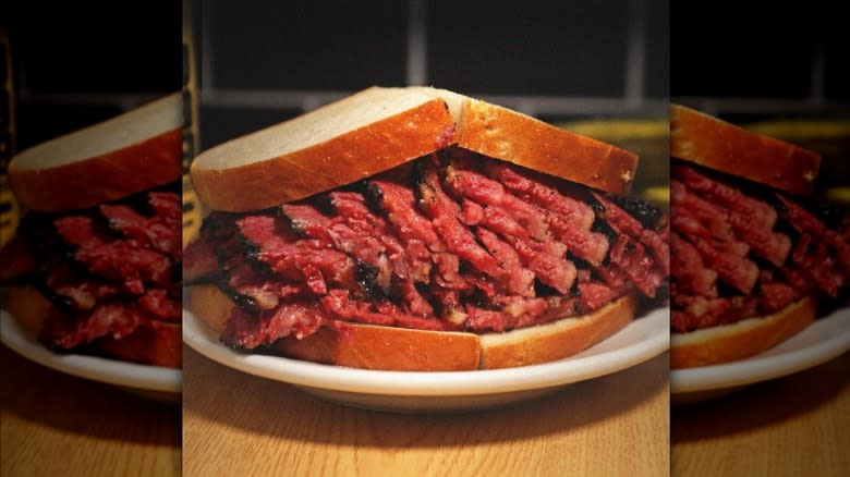 A close-up of a Katz's Deli pastrami sandwich, full of melt-in-your-mouth pastrami.