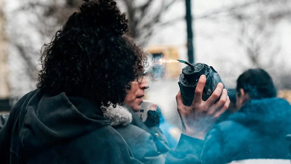 A man identified by authorities as Emir Balat is seen with a flaming device at the scene of an anti-Islam protest and counterdemonstration Saturday. - Eduardo Munoz/Reuters