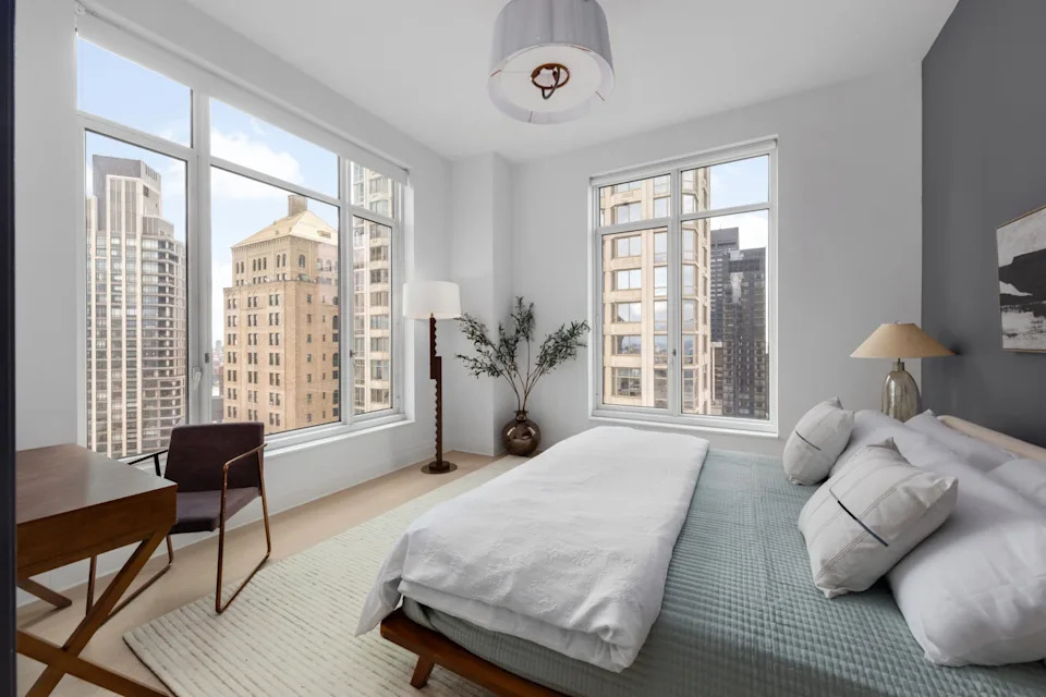 A bedroom with city views in the Four Season Duplex in Manhattan New York