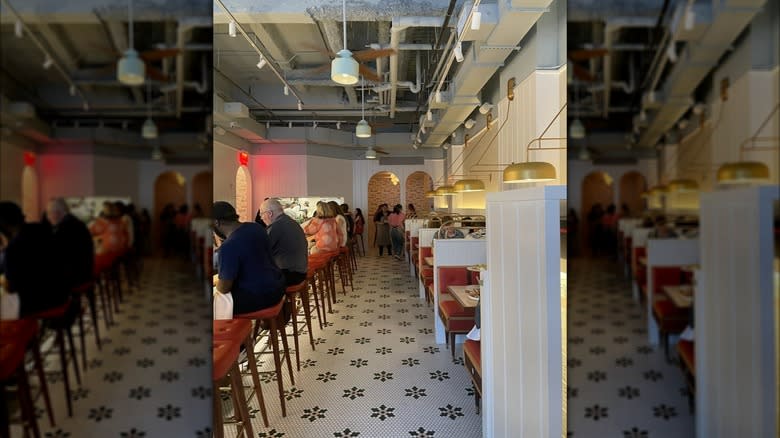 White interior with seated diners in Stretch Pizza, NYC