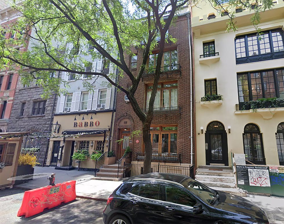 Urban street view featuring a restaurant and residential buildings.
