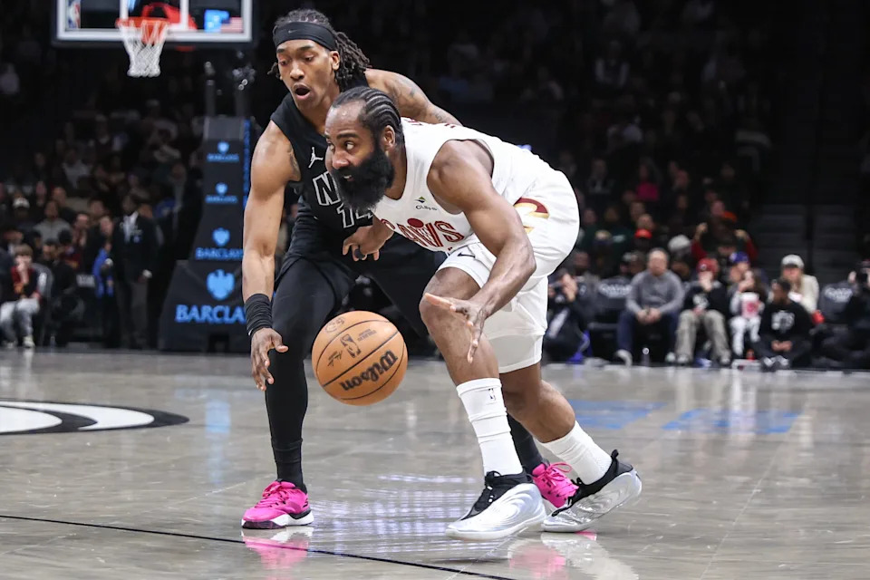 Cleveland Cavaliers guard James Harden, right, drives past Brooklyn Nets guard Terance Mann (14) on March 1, 2026, in Brooklyn, New York.