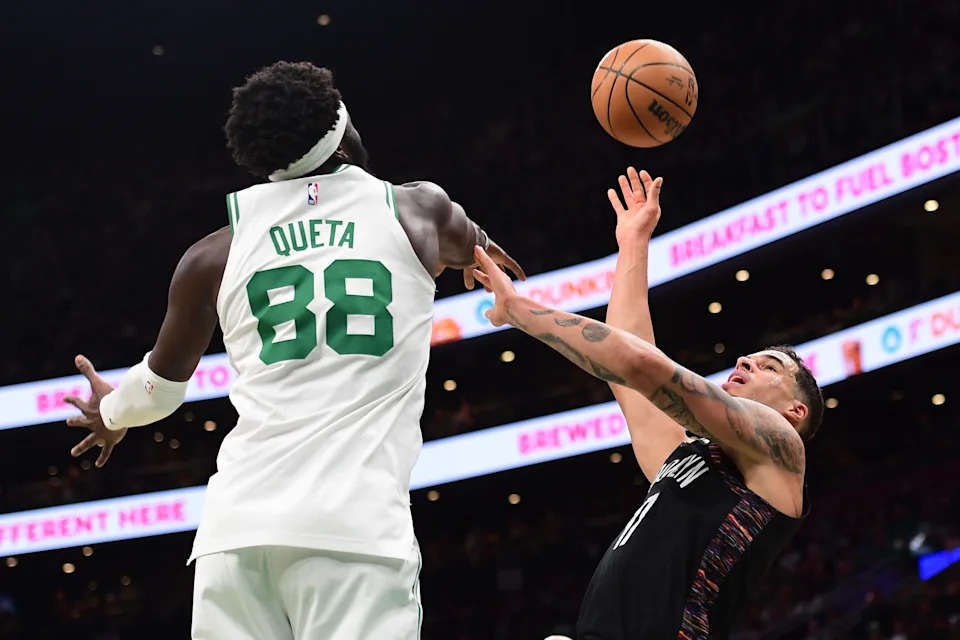 Feb 27, 2026; Boston, Massachusetts, USA; Brooklyn Nets forward Michael Porter Jr. (17) shoots the ball while Boston Celtics center Neemias Queta (88) defends during the first half at TD Garden. Mandatory Credit: Bob DeChiara-Imagn Images