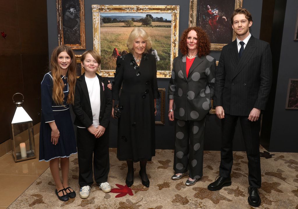 Queen Camilla poses with actor Olivia Lynes (L), actor Jacobi Jupe (2L), author Maggie O'Farrell (2R) and actor Joe Alwyn 