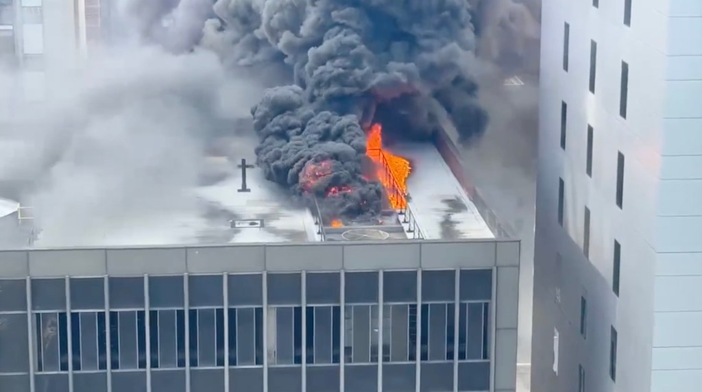 Fire and smoke on the roof of a midtown building.