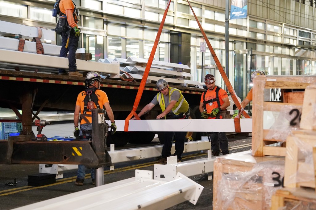 Workers unload steel beams at the JPMorgan Chase headquarters construction site.