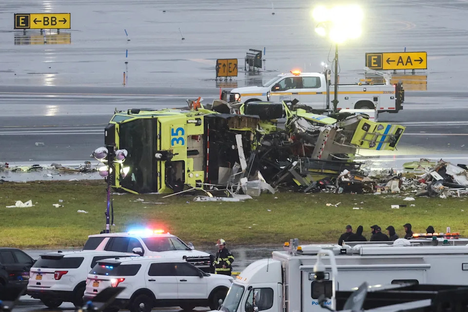 A damaged Port Authority fire truck sits near the runway after colliding with an Air Canada Express CRJ-900 at LaGuardia Airport in New York, on March 23.