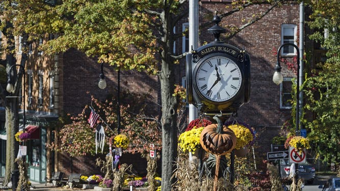 SLEEPY HOLLOW, NEW YORK, UNITED STATES - 2014/10/27: Town clock with autumn decorations.