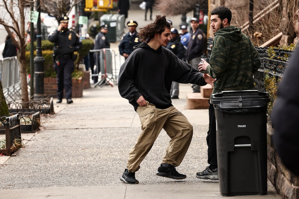 PHOTO: A left-wing activist is handed a homemade explosive device by a fellow activist before throwing it towards police during a protest in front of Gracie Mansion, on March 7, 2026, in New York.