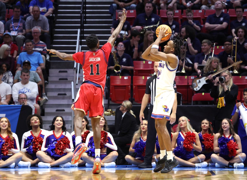 St. John's Red Storm player Ian Jackson jumps to block a shot by Kansas Jayhawks player Darryn Peterson during the NCAA Tournament.