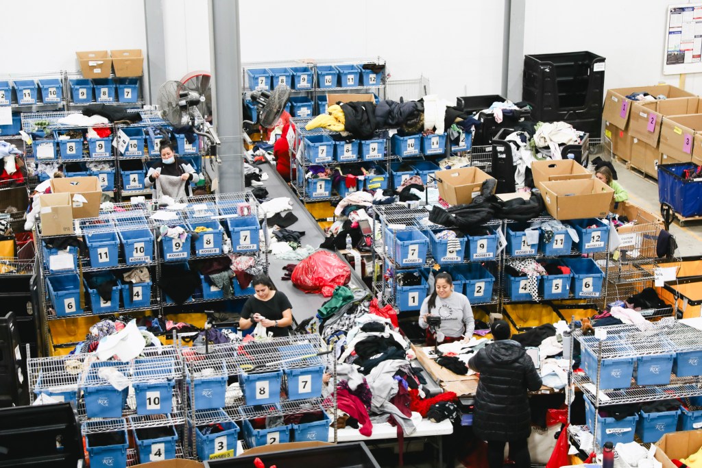 Employees sort clothing by material and color at Helpsy's facility in Eatontown