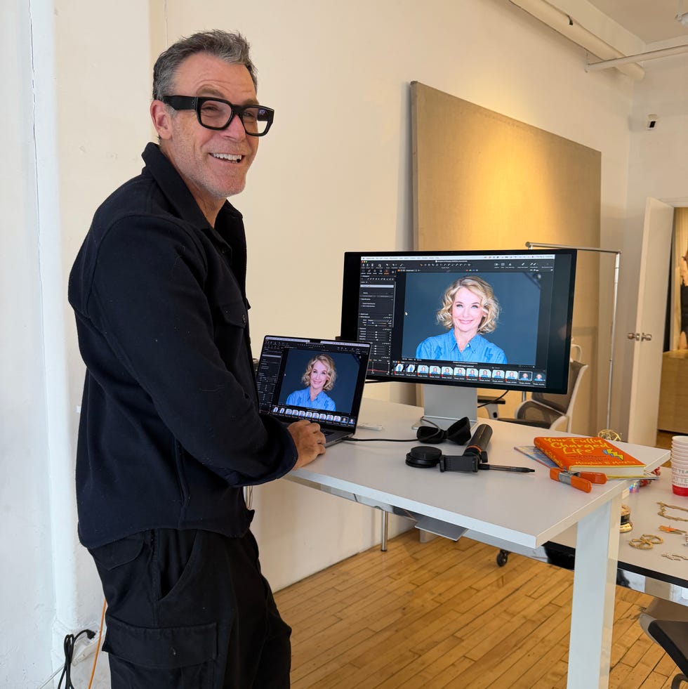 person using a laptop and desktop computer in a workspace