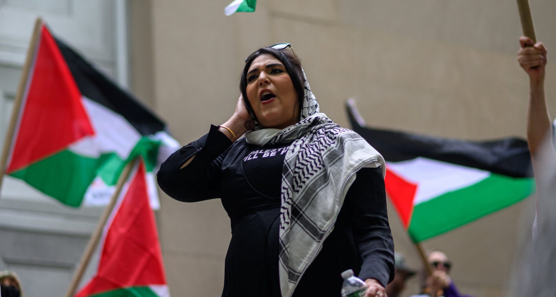 A photo of Kiswani speaking during a rally.