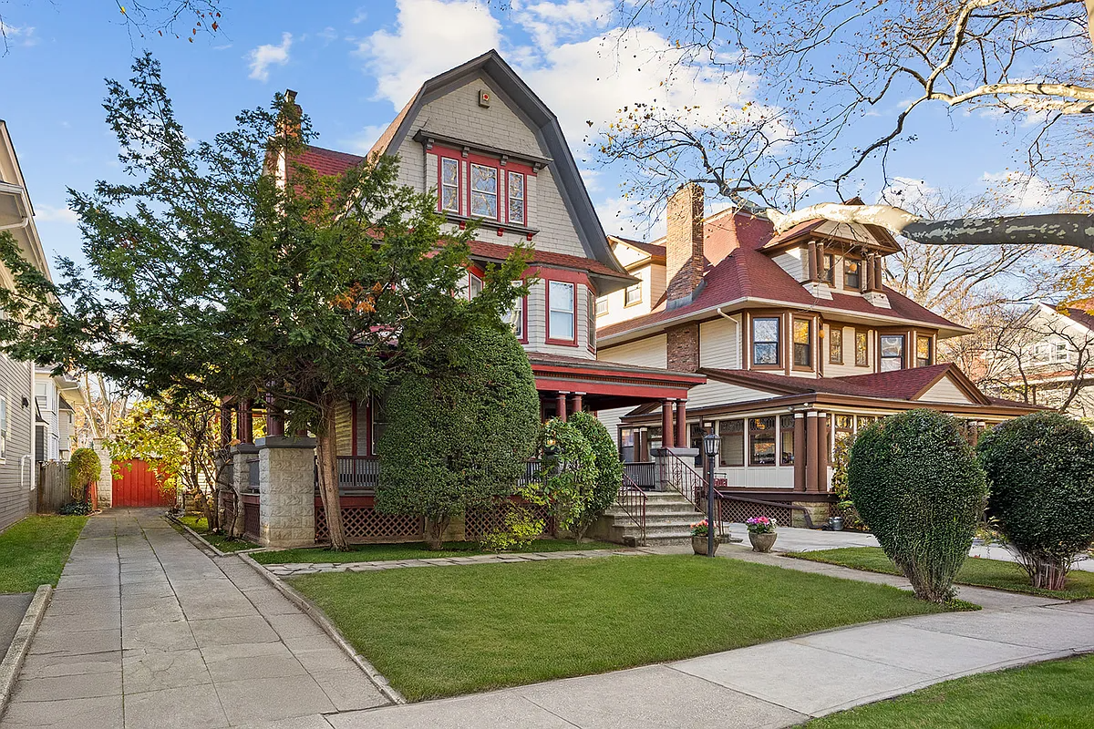 standalone house with gambrel roof and a porch