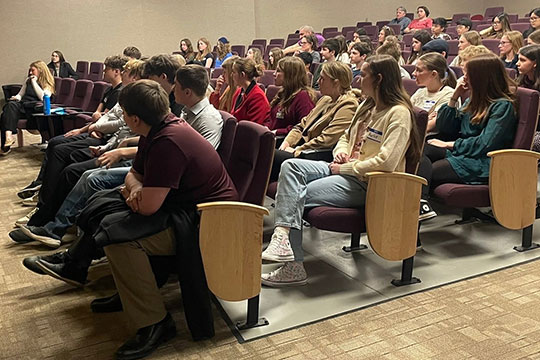 group of youngsters sitting in an auditorium