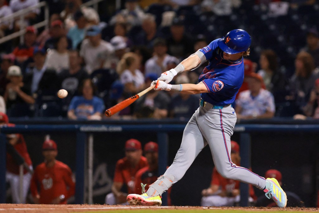 New York Mets right fielder Carson Benge (93) hitting an RBI single against the Washington Nationals during the fifth inning of a Spring Training game.