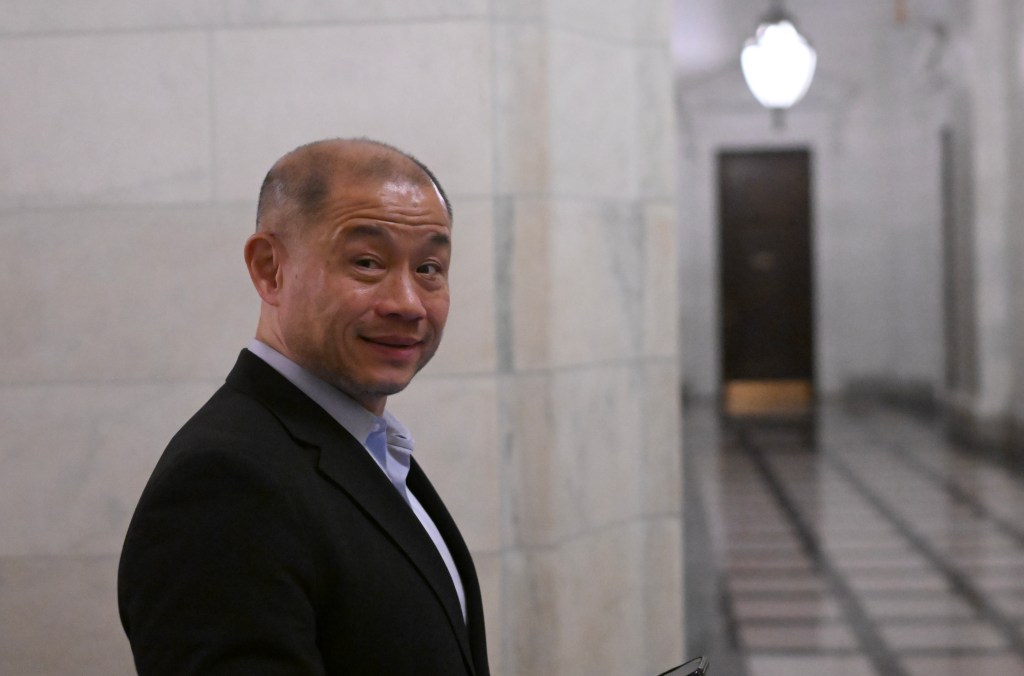 New York Sen. John Liu heads to a conference at the state Capitol.