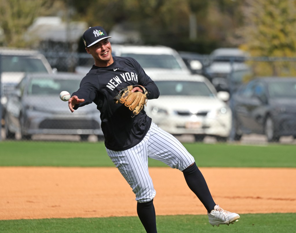 Anthony Volpe throwing a ball during practice at Steinbrenner Field.
