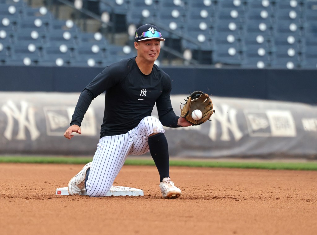 New York Yankees shortstop Anthony Volpe catching a baseball at 2nd base during a workout.