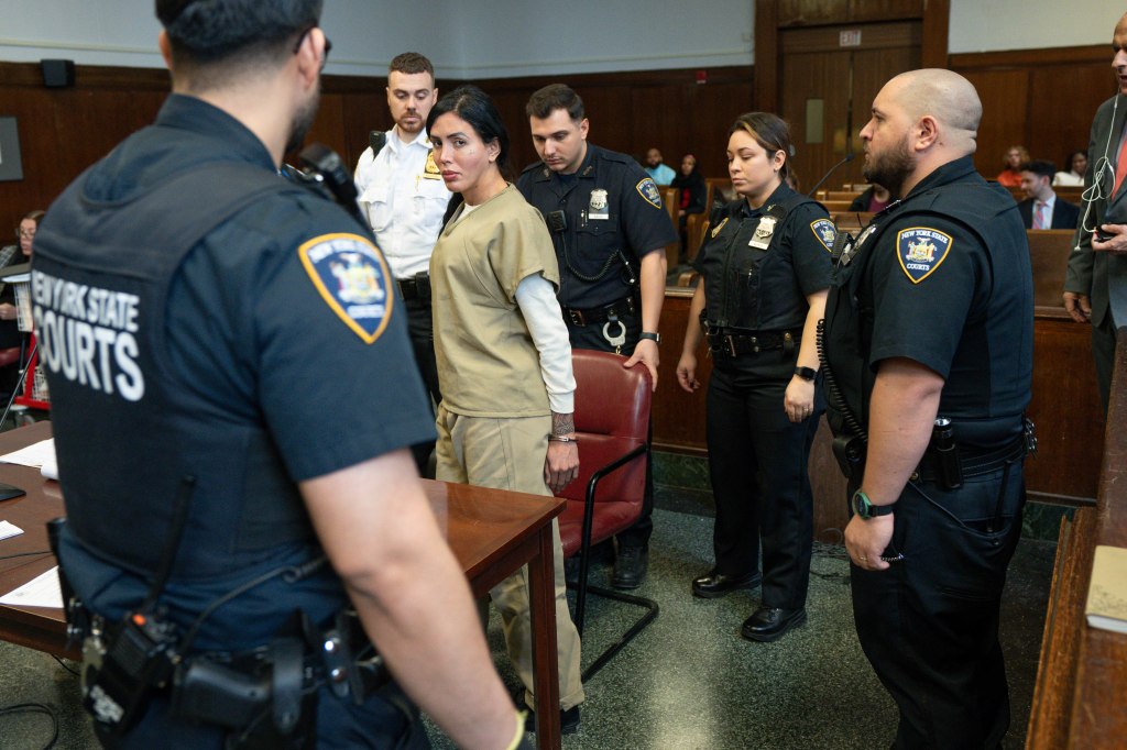 Nicol Suarez, a migrant transgender woman, in a courtroom surrounded by court officers.