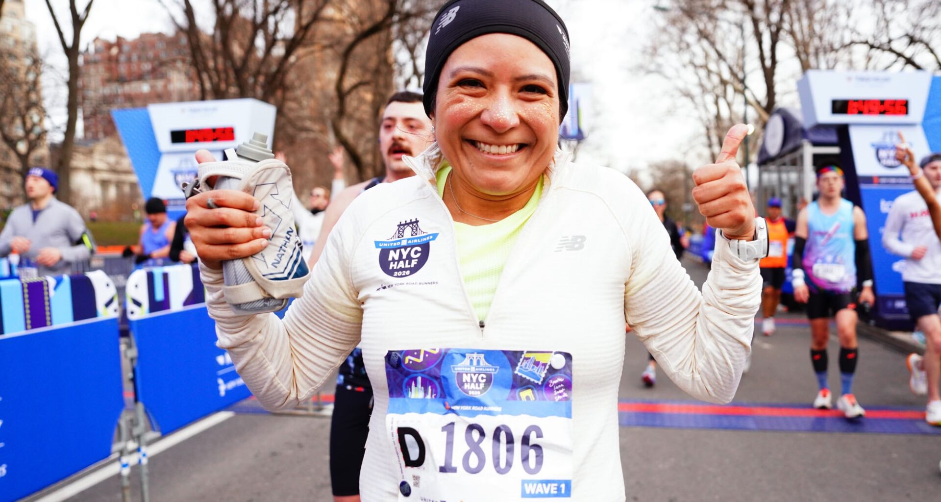 Woman runner with glitter on face just after finish of 2026 United Airlines NYC Half in Central Park