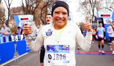 Woman runner with glitter on face just after finish of 2026 United Airlines NYC Half in Central Park