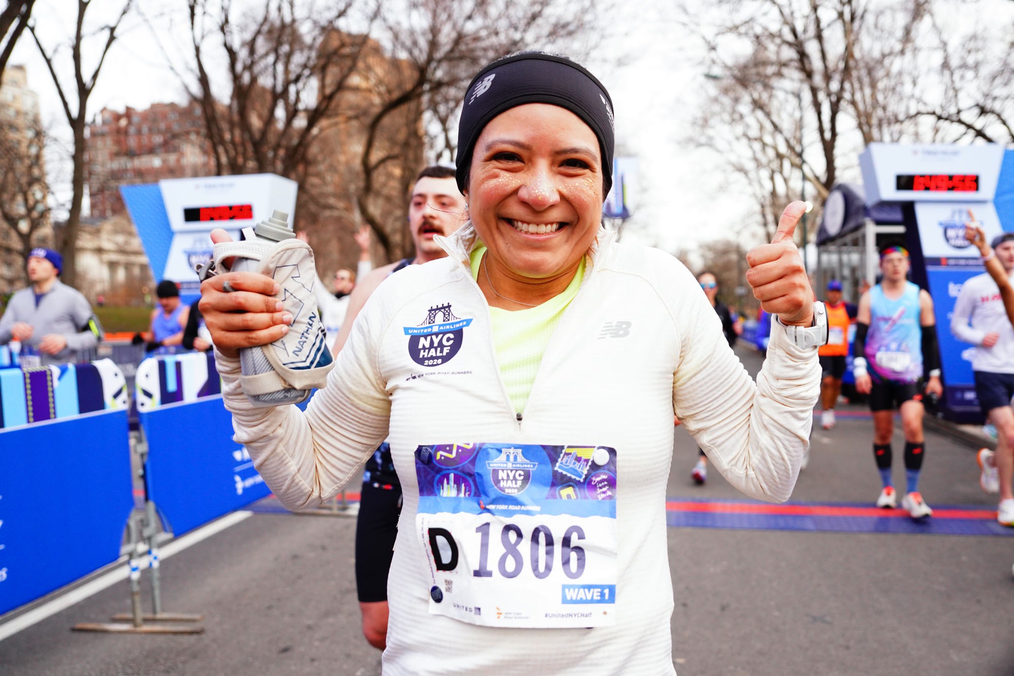 Woman runner with glitter on face just after finish of 2026 United Airlines NYC Half in Central Park
