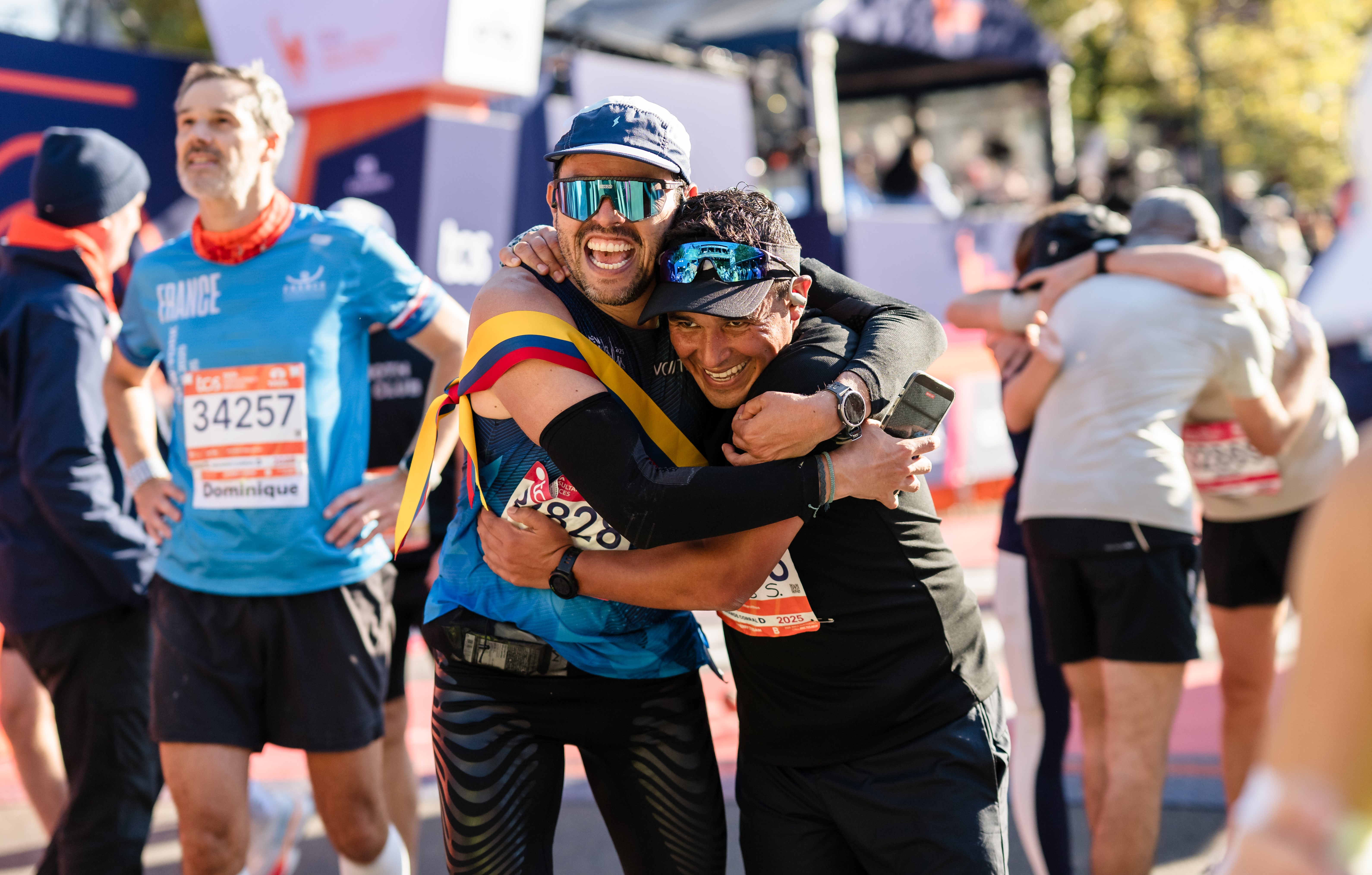 Two men hugging after finishing the 2025 TCS New York City Marathon.