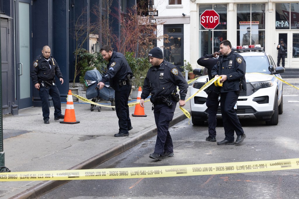 NYPD 1st pct officers at the scene of a slashing friday March 20th, a security guard at Palace, a skateboard shop at 49 Howard Street in soho
