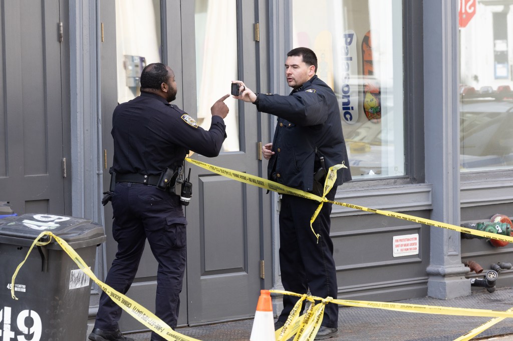 NYPD 1st pct officers at the scene of a slashing friday March 20th, a security guard at Palace, a skateboard shop at 49 Howard Street in soho