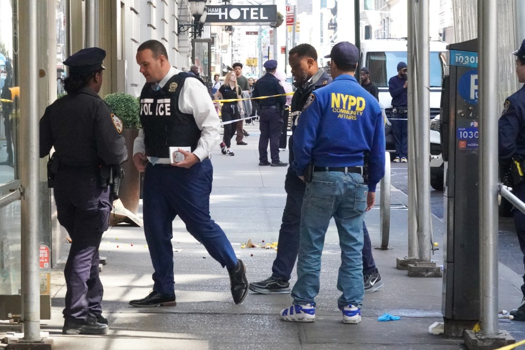 NYPD officers investigate a daylight shooting on E 28th St. in New York City.