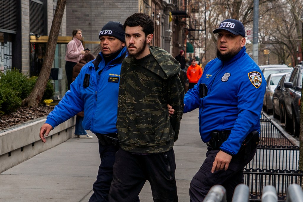 Counter-protester Ibrahim Kayumi is detained by NYPD officers during an anti-Islam protest in New York City.