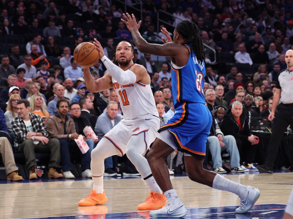 New York Knicks guard Jalen Brunson (11) goes up for a shot as Oklahoma City Thunder guard Cason Wallace (22) defends during the first quarter.