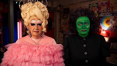 Two people in fancy dress as characters from the Wizard of Oz. 