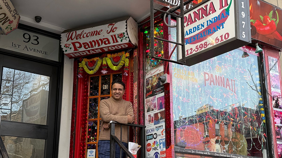 Khan stands outside his restaurant, Panna II.