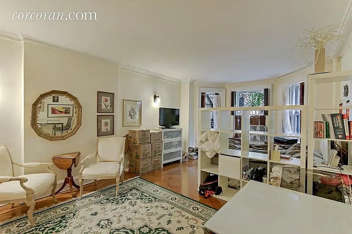living space with bookshelves dividing sleeping area