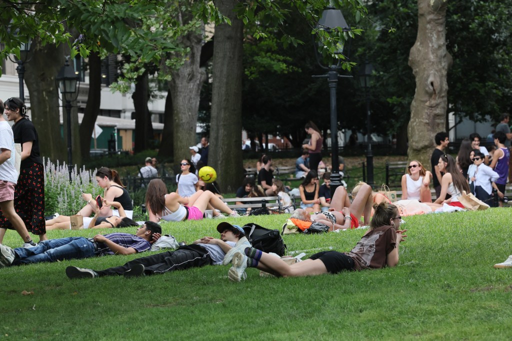 People enjoying the weather in Washington Square Park.
