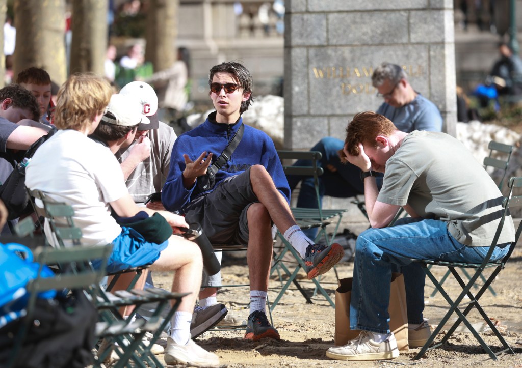 A group of young men in Bryant Park, NYC on a sunny day.