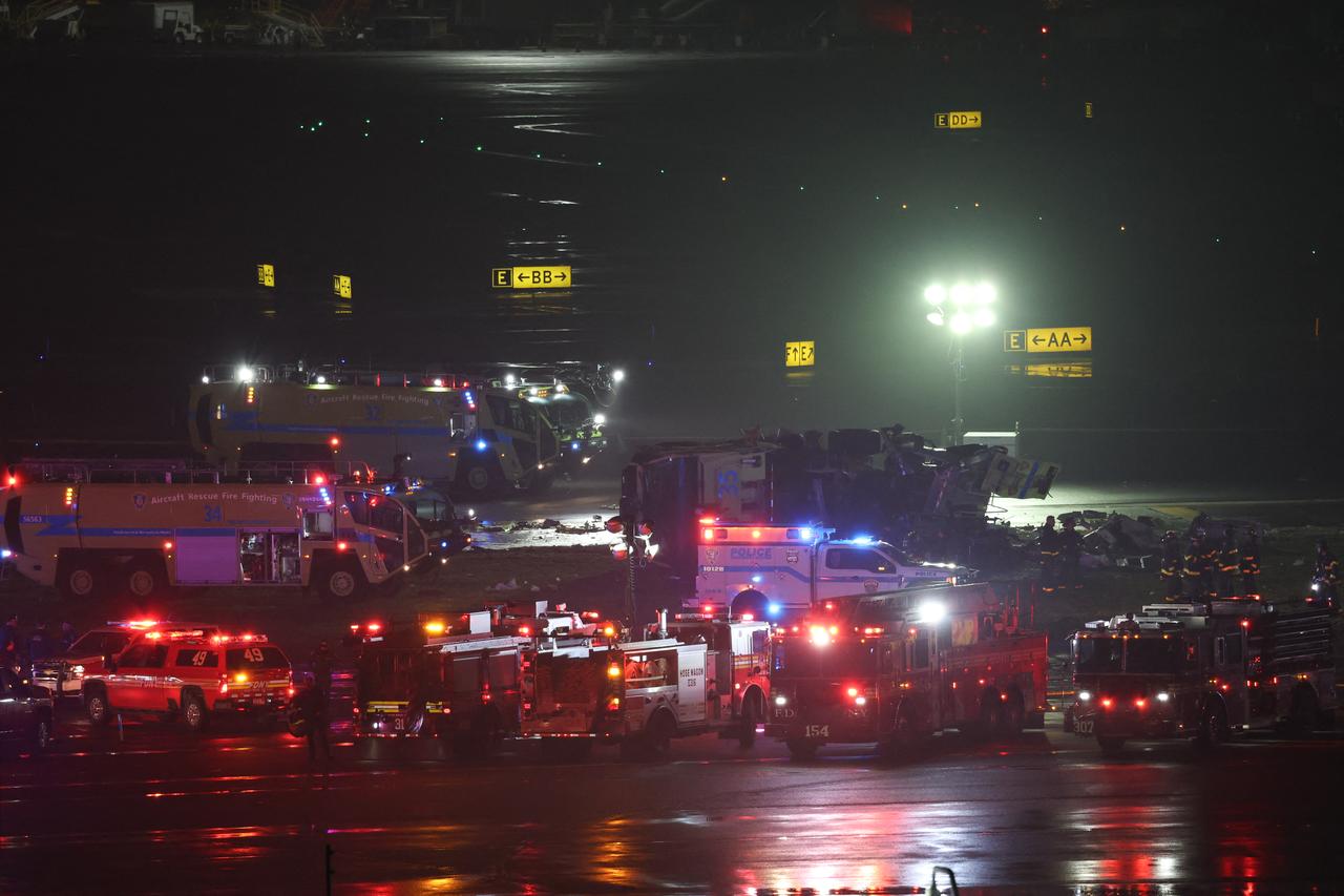 Emergency personnel respond to an Air Canada Express CRJ-900 after colliding with a Port Authority fire truck at LaGuardia Airport in New York, March 23, 2026. (AFP Photo)