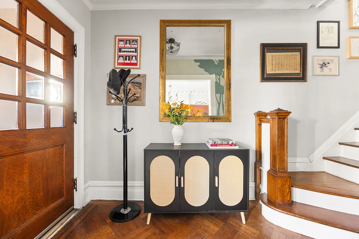 entry with wood floor, new staircase