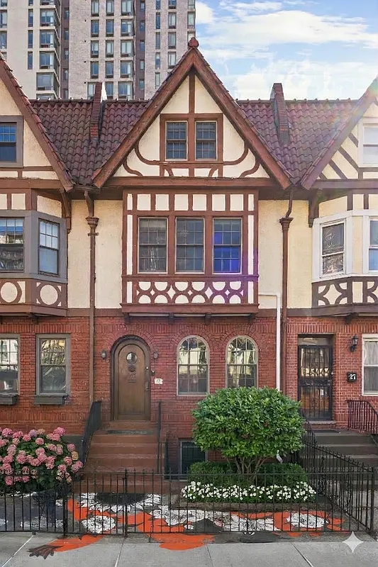 tudor row house exterior with brick main level and stucco and half timbering above