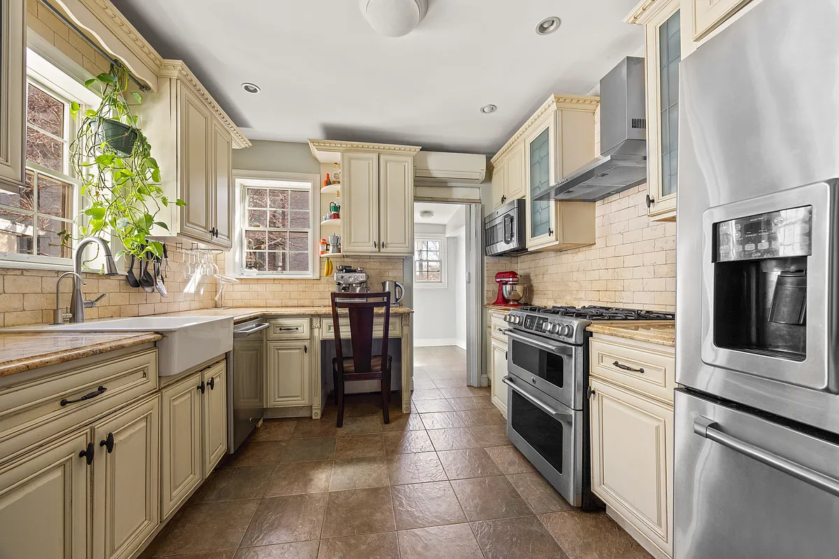kitchen with cream cabinets, tile floor