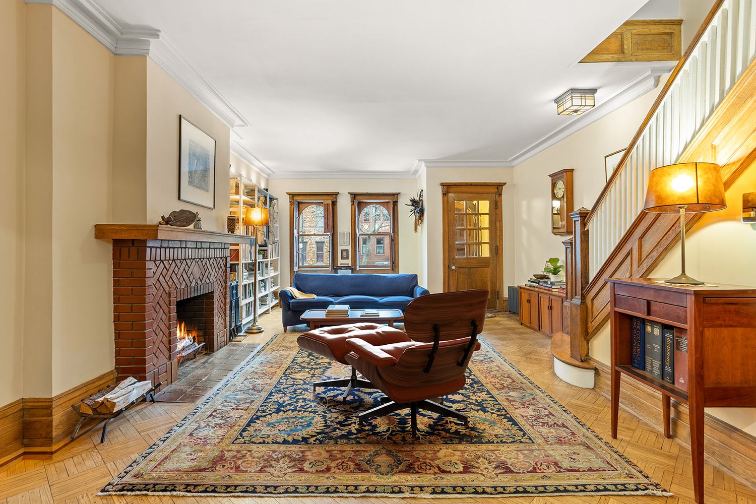 living room with brick mantel, wood floor