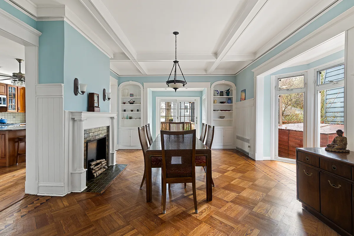dining room with built-in bookcases, mantel