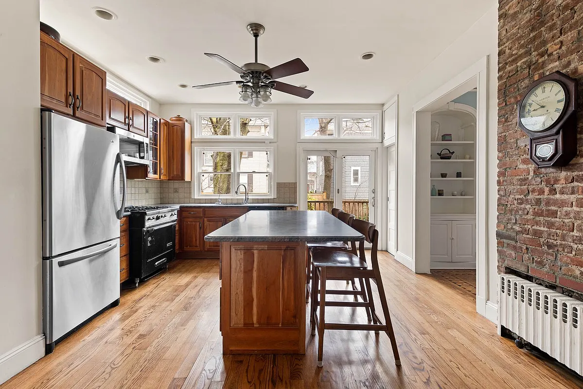 kitchen with exposed brick, island